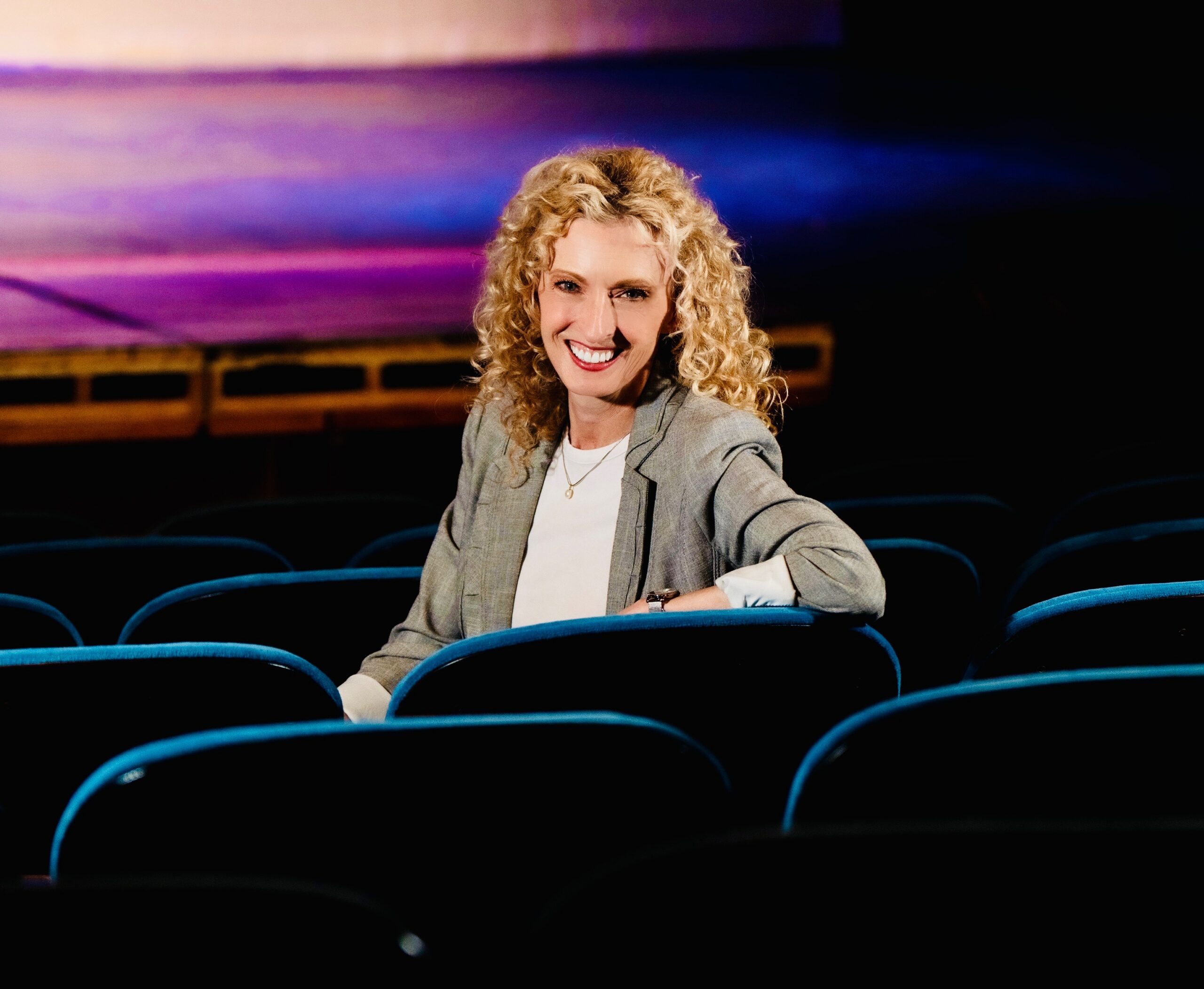 Susan Varela Sitting in theatre seats