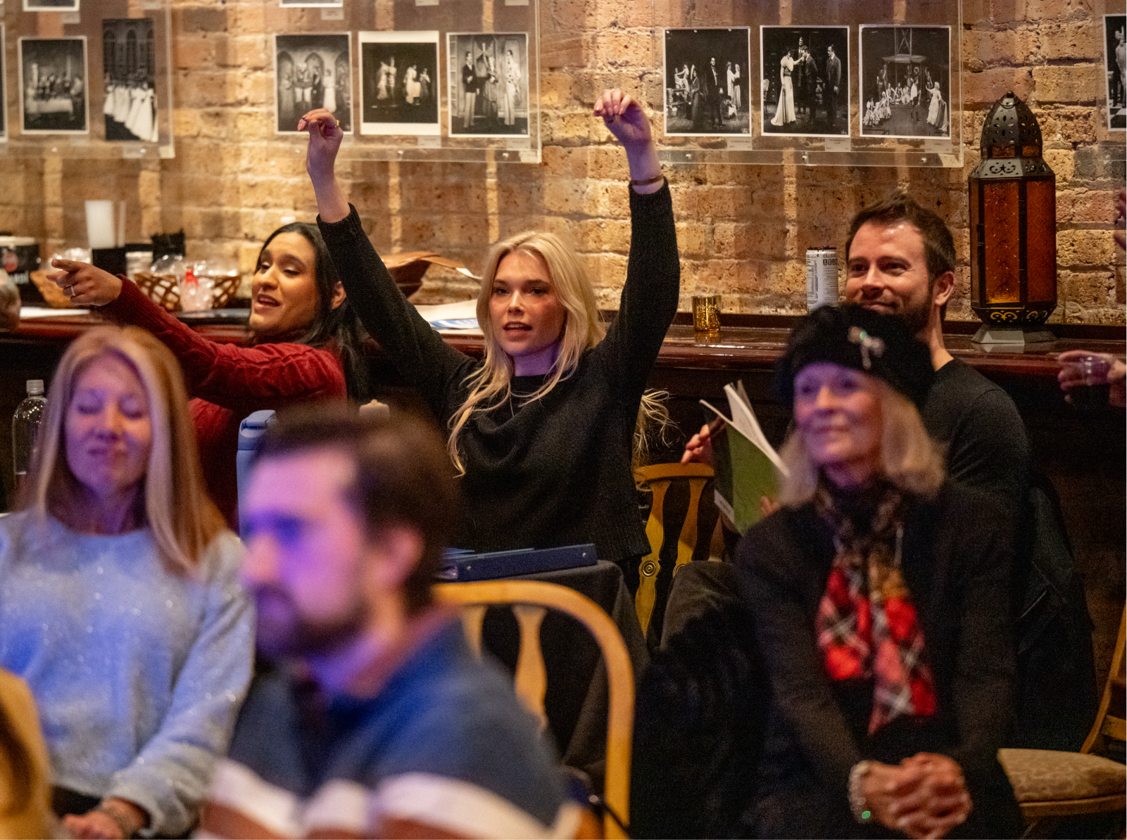 Audience Members raising their hands in seats