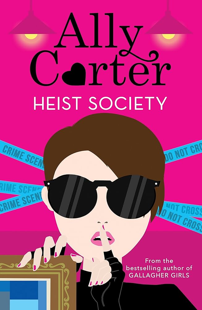 A woman in sunglasses holds a frame and gestures for silence. Pink background, "Ally Carter Heist Society." Blue crime scene tape visible.