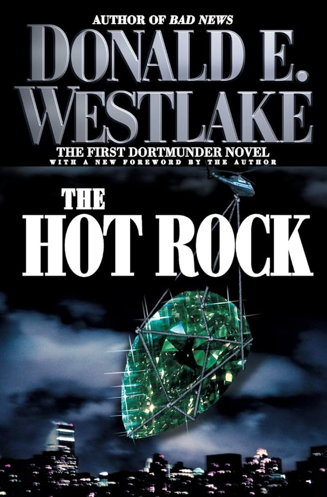 Title "The Hot Rock" by Donald E. Westlake. A helicopter lifts a large green gem over a city skyline at night. Mysterious mood.