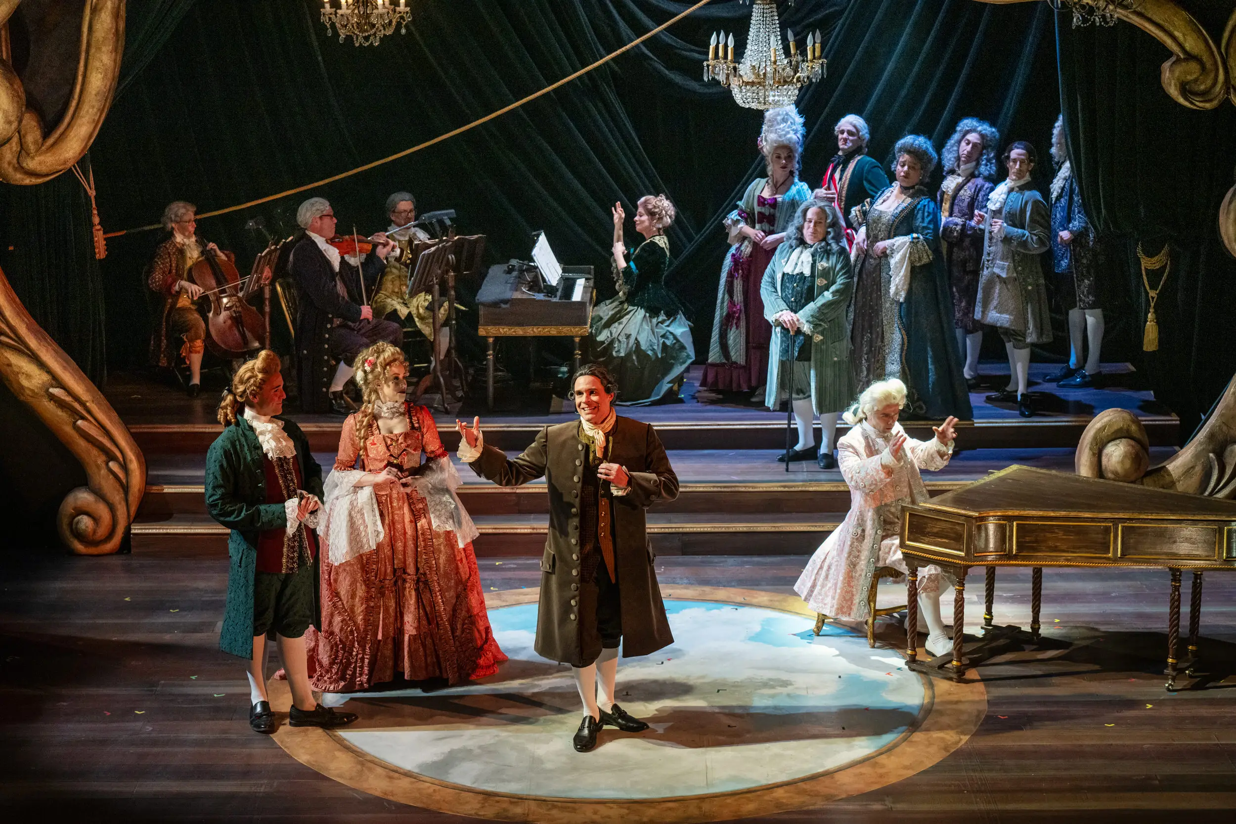 Performance of Amadeus, multiple actors on stage and around a piano.