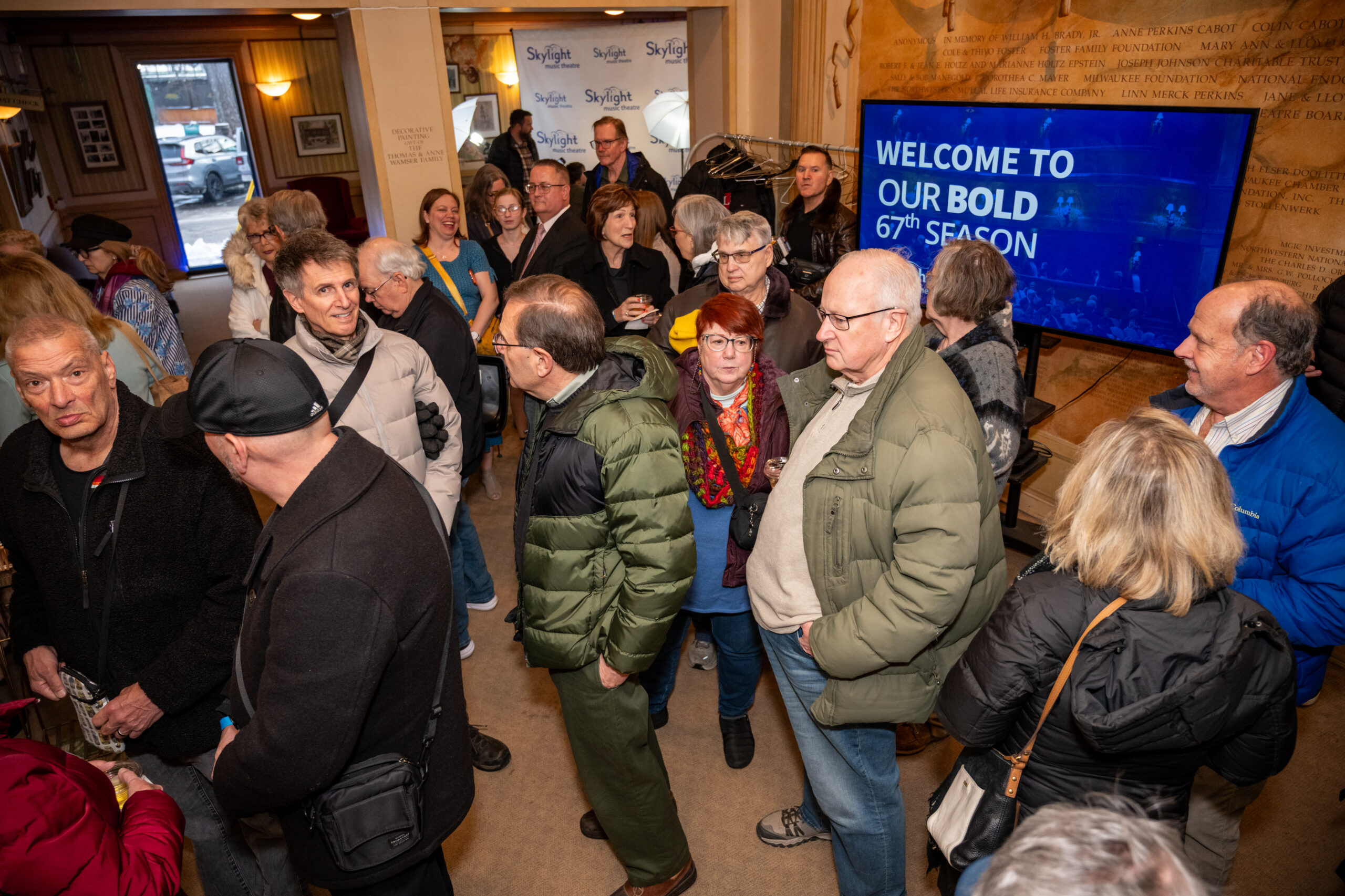 A crowded theatre lobby.