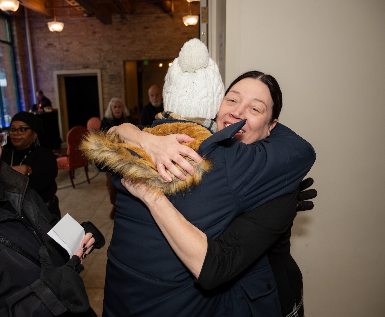 Two people hugging in the lobby