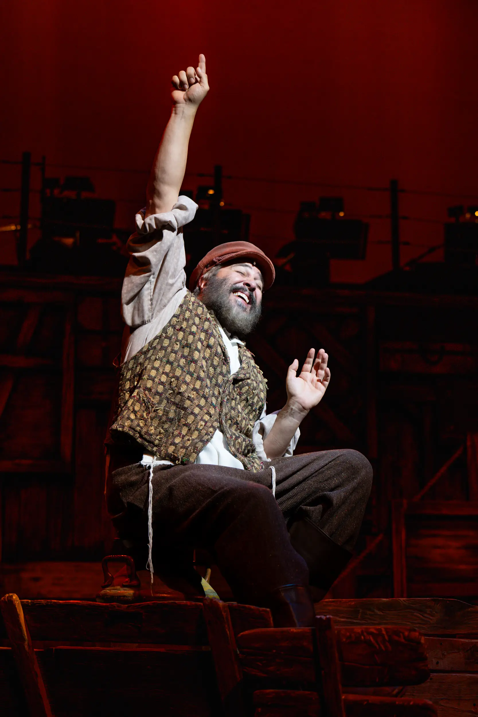 Actor raising hand and signing for a Fiddler on the Roof Performance.