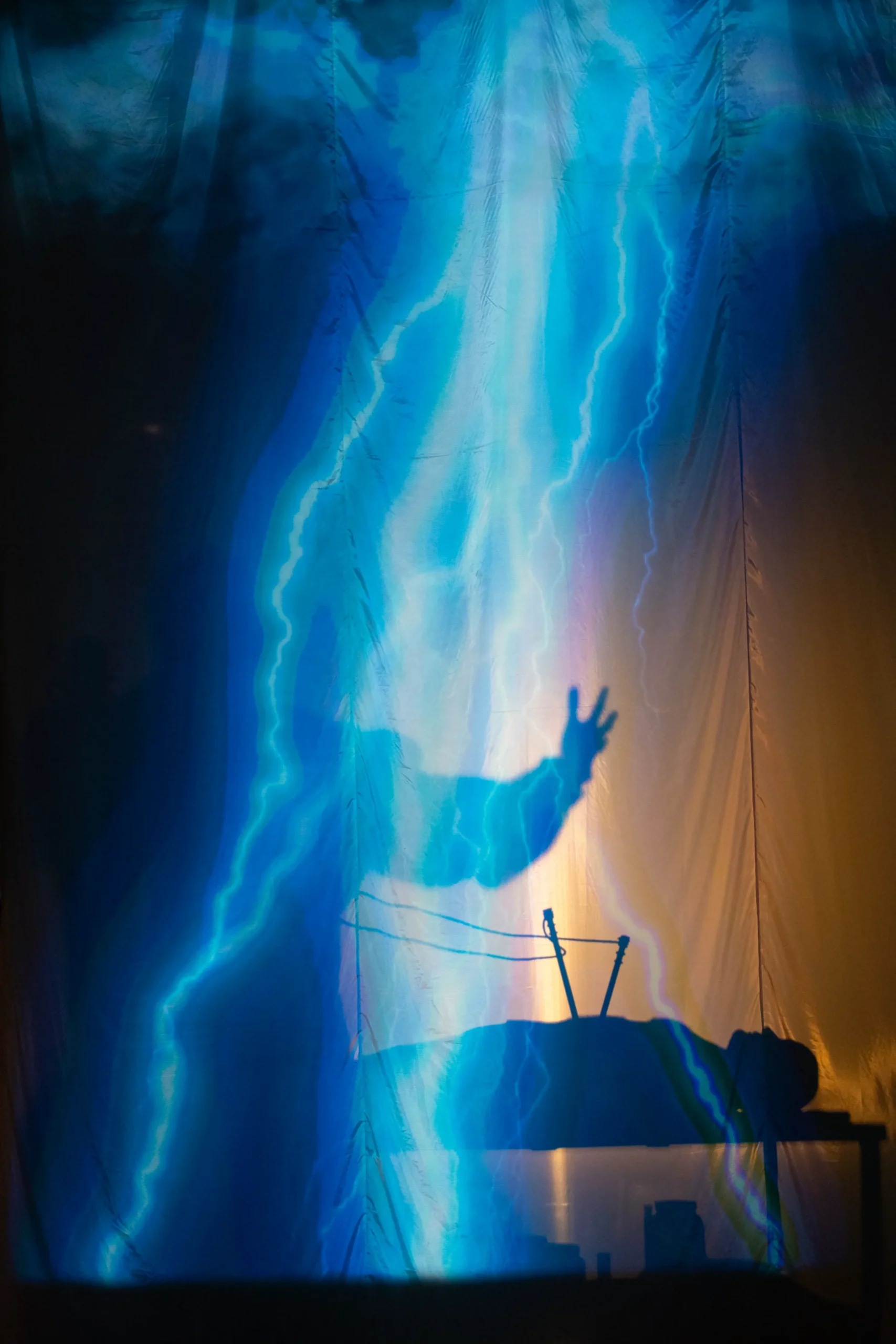 Silhouette of Frankenstien on stage singing during Frankenstein performance