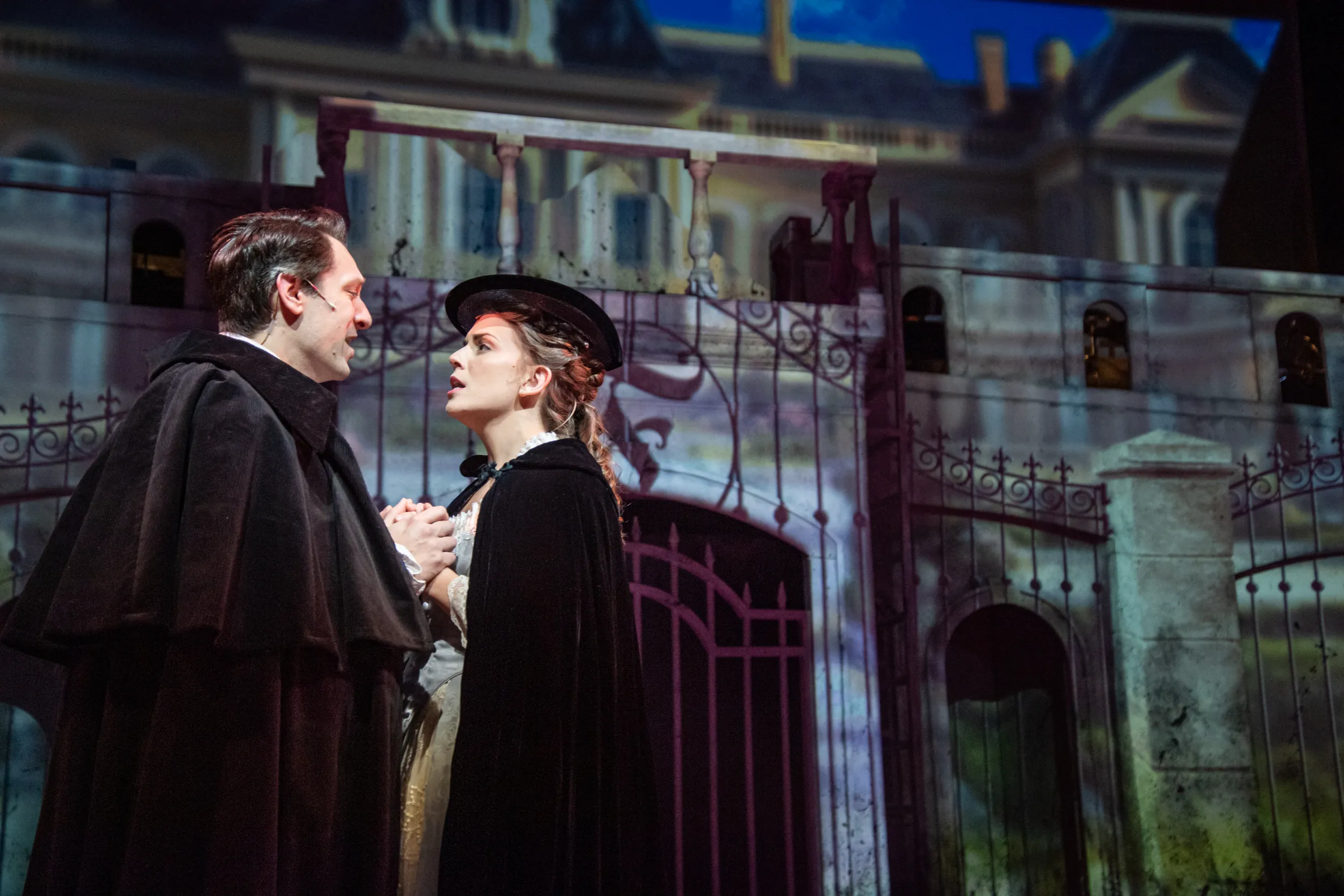 Two actors on stage signing during Frankenstein performance