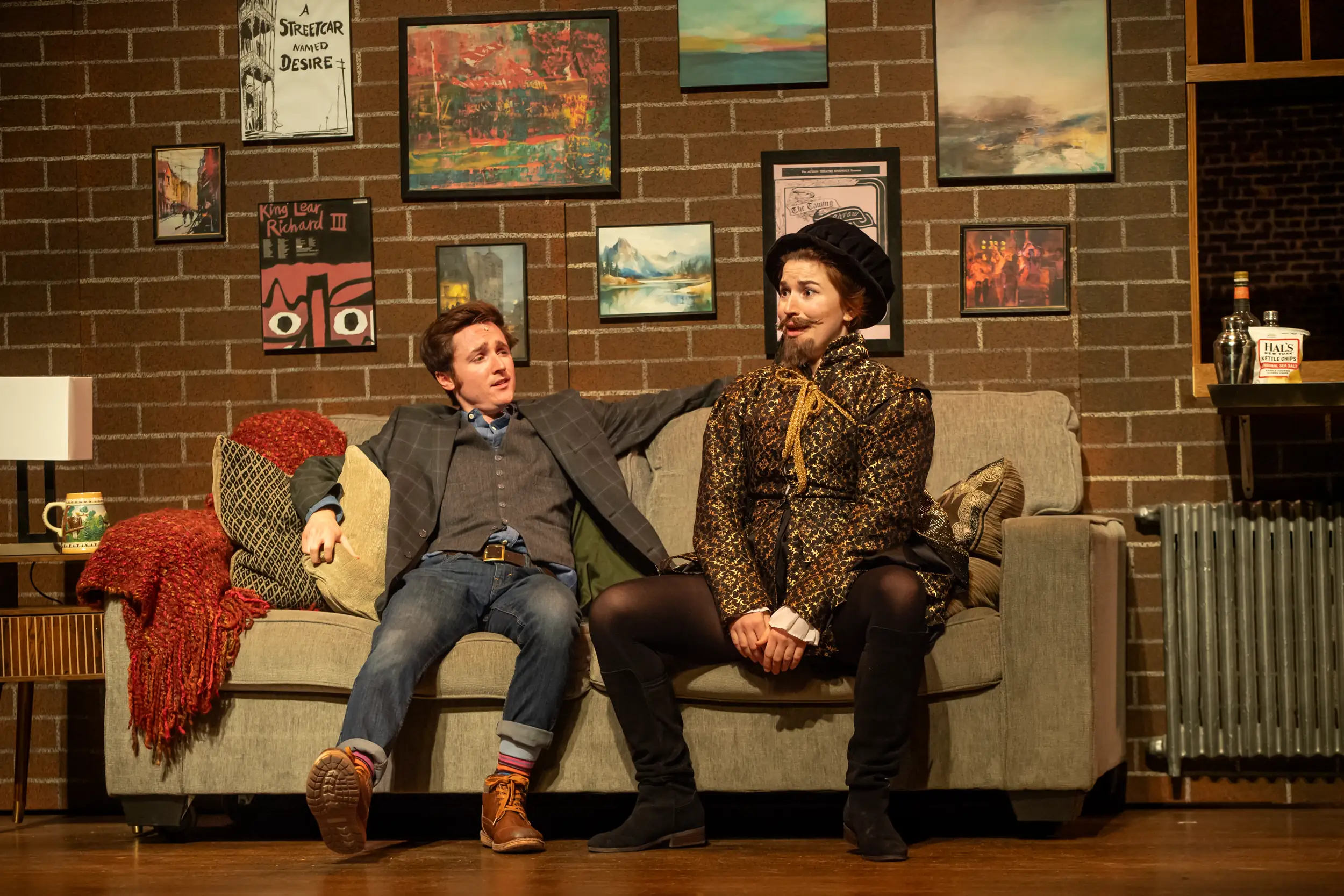 Two actors on couch during Juliet and Romeo play
