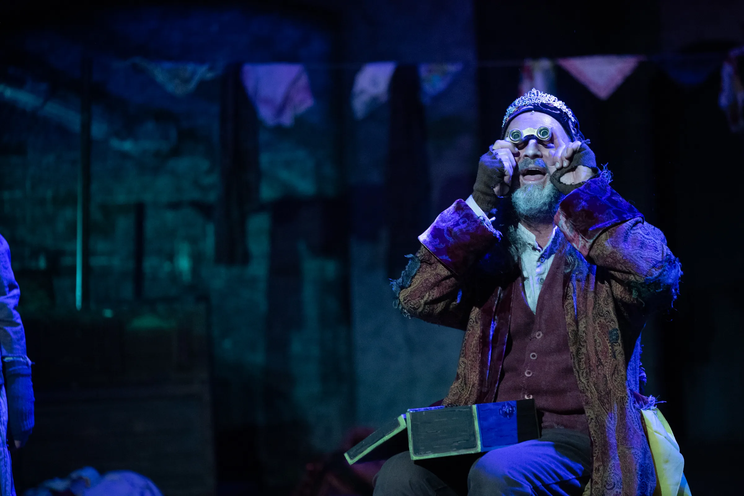 One performer looking through binoculars for Oliver Performance