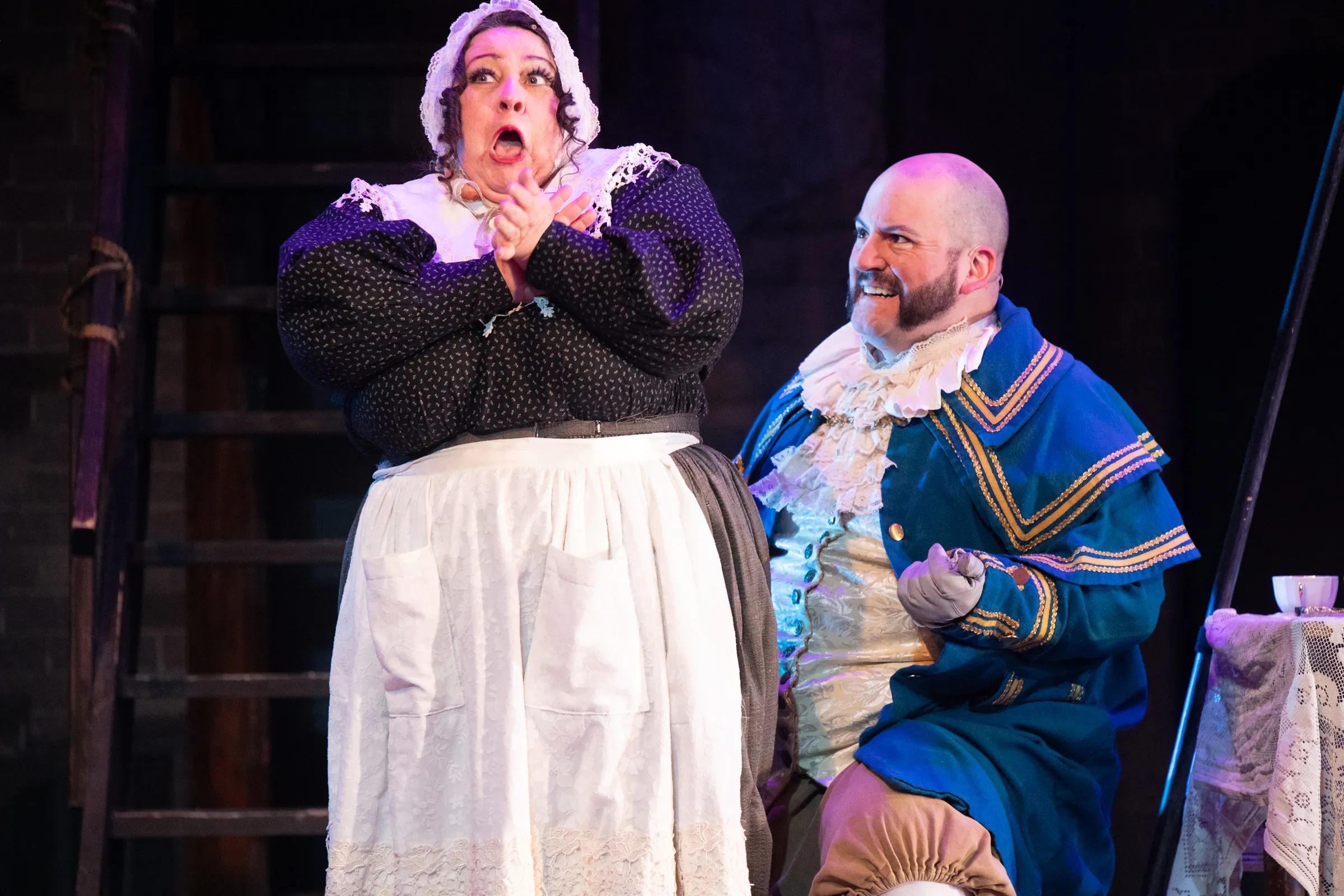 Actors on stage, a man and a woman, for Oliver performance