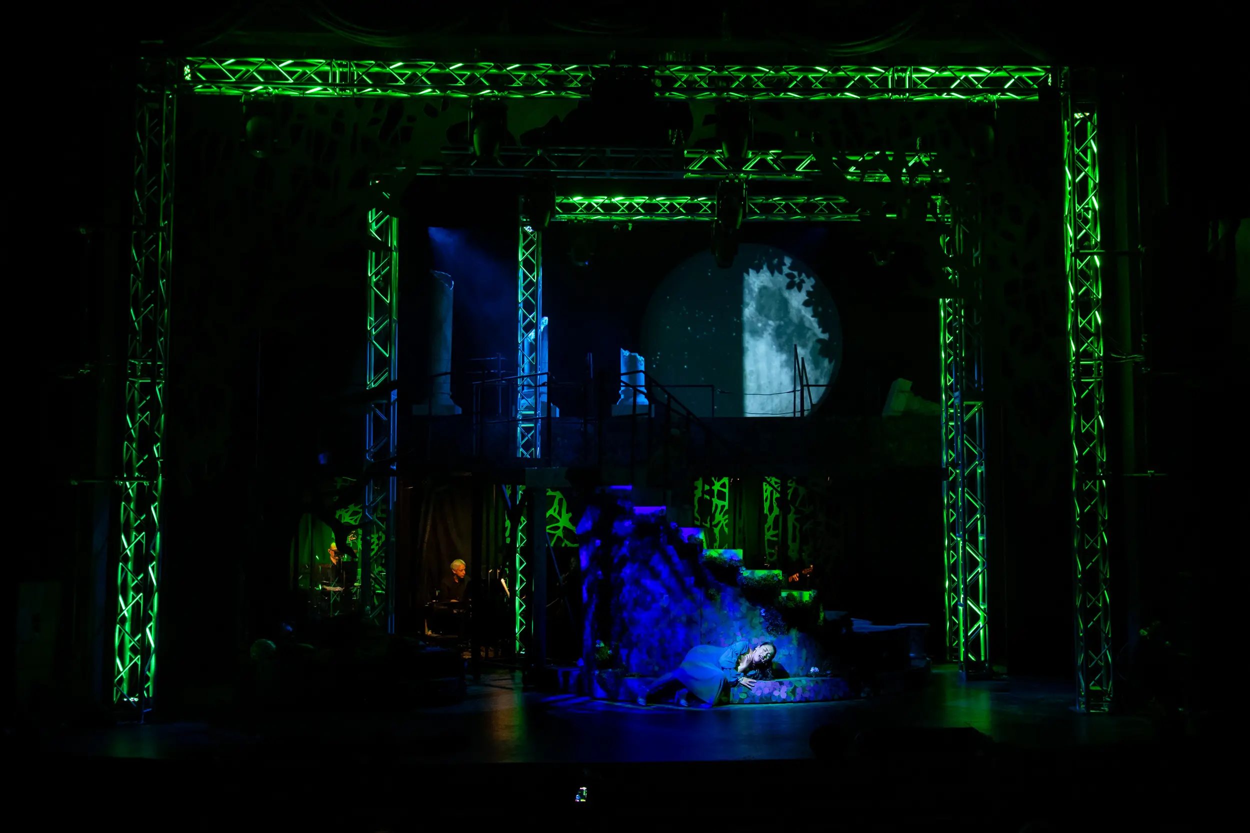 Woman singing solo below the moon as part of the Rockin Midsummer Nights Dream performance