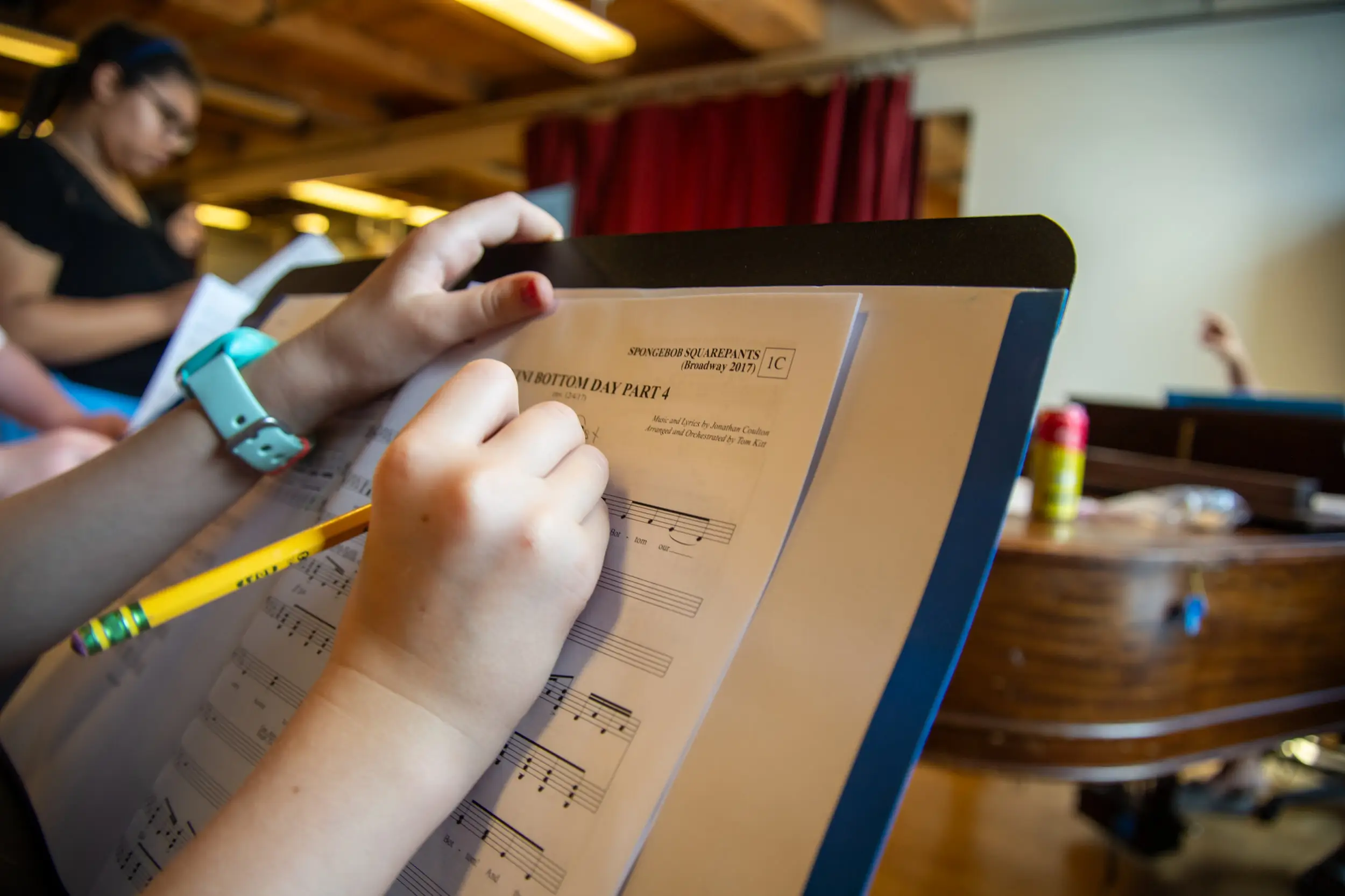 Kids writing notes on their sheet music
