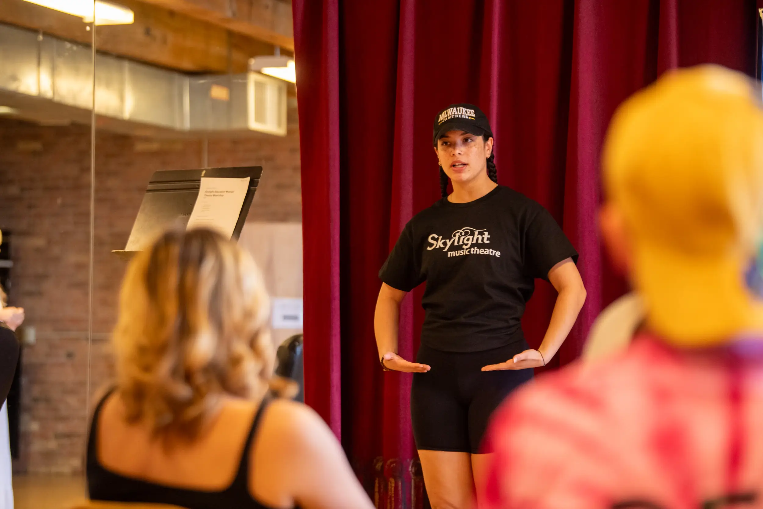 Woman leading a summer theatre camp