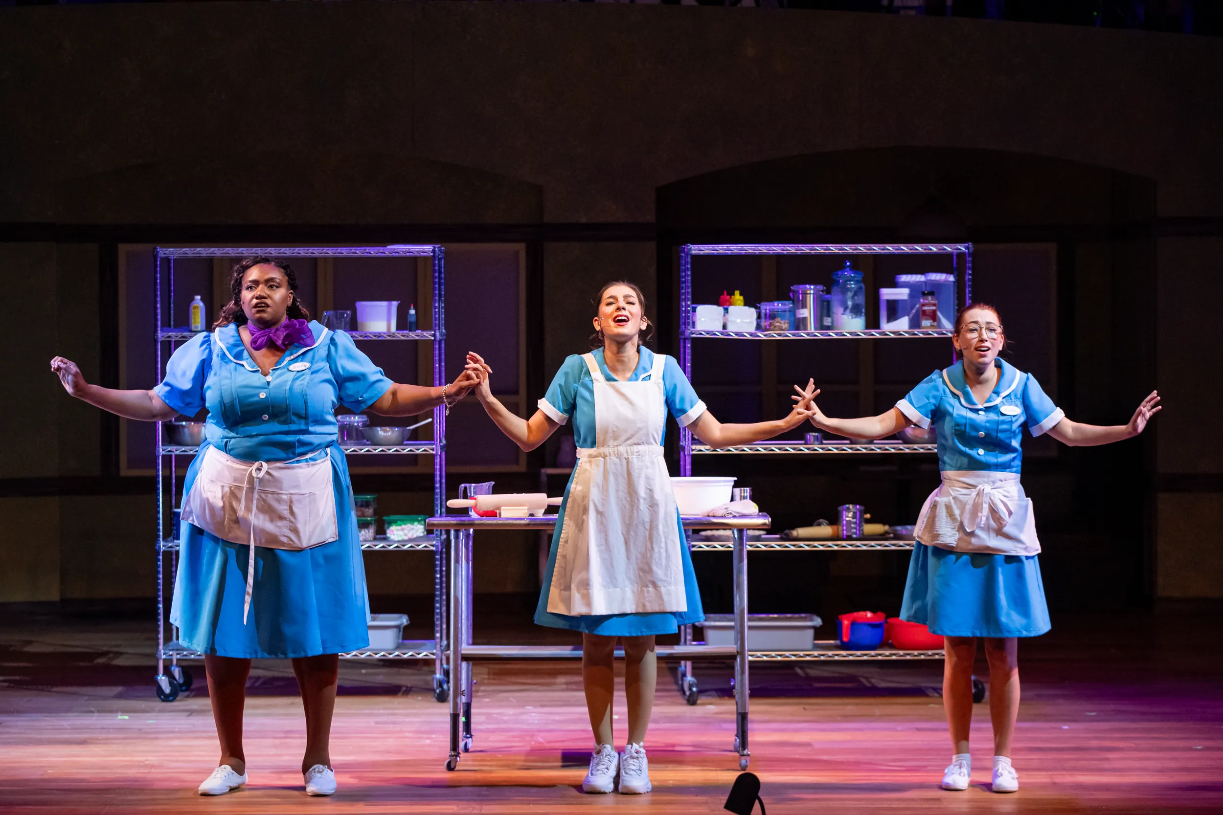 Three waitresses singing during Waitress performance