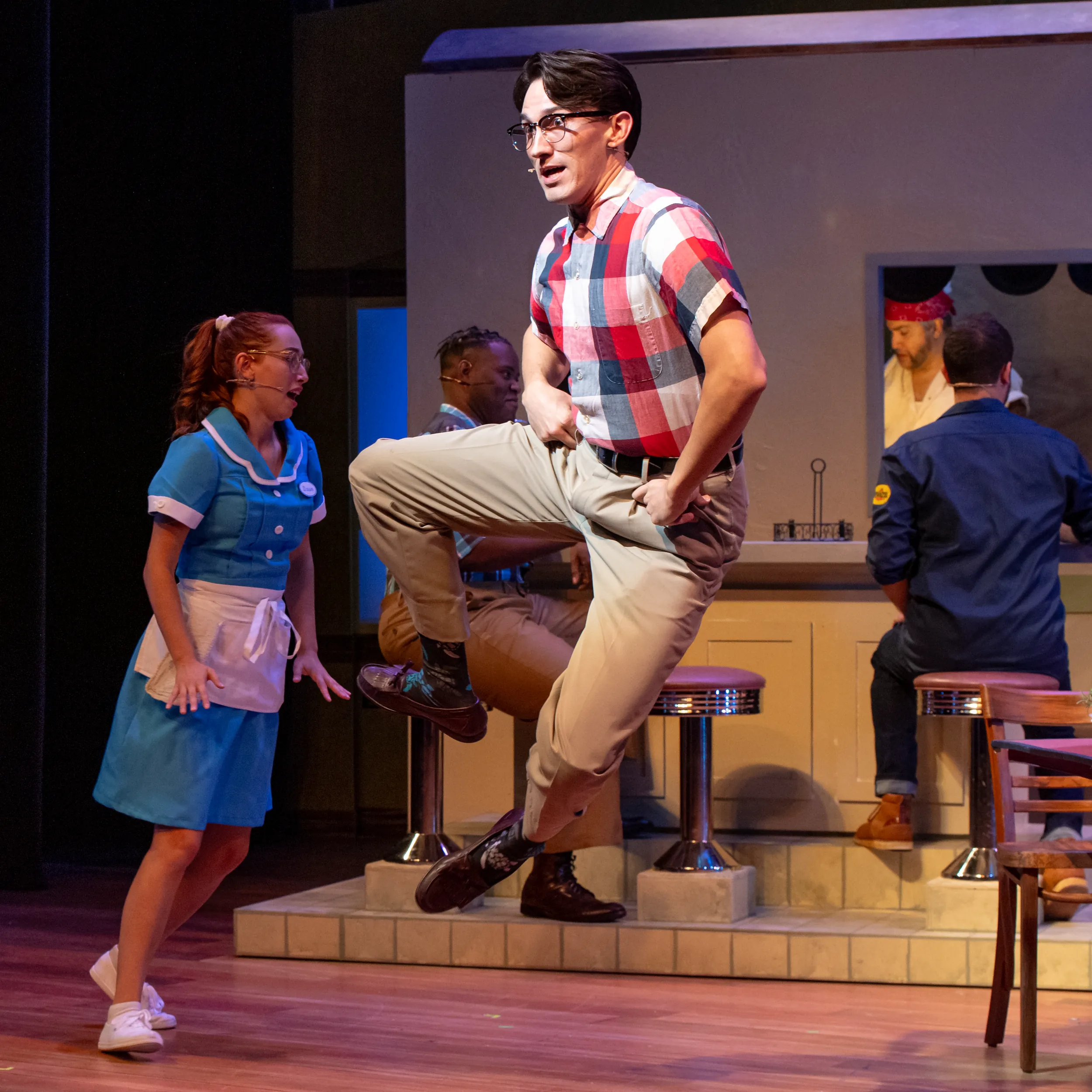 One man skipping and kicking heels during Waitress performance